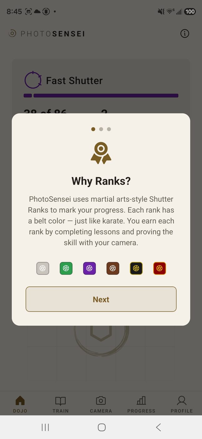 A Why Ranks? card explaining that PhotoSensei uses martial arts-style Shutter Ranks to mark progress, with the six rank chips shown in a row beneath it.